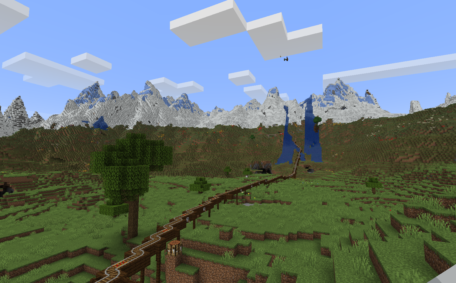 Green plains with an oak tree and a mountain range in the distance